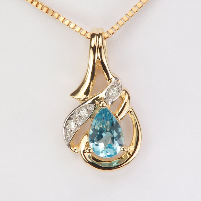 pear shape greenish blue topaz gem pendant with diamonds in yellow gold