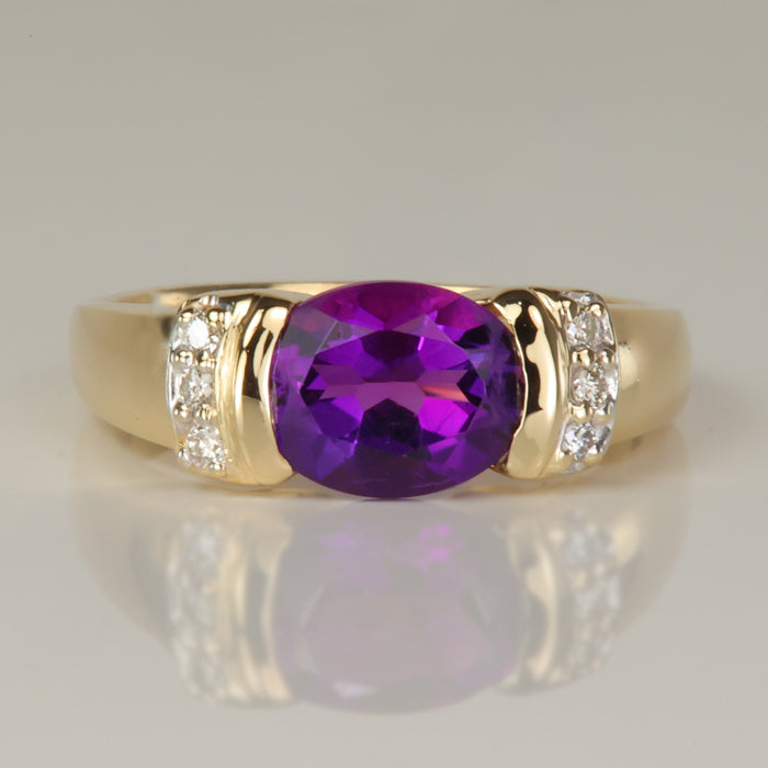 oval cut amethyst gemstone ring with diamond accents in yellow gold 