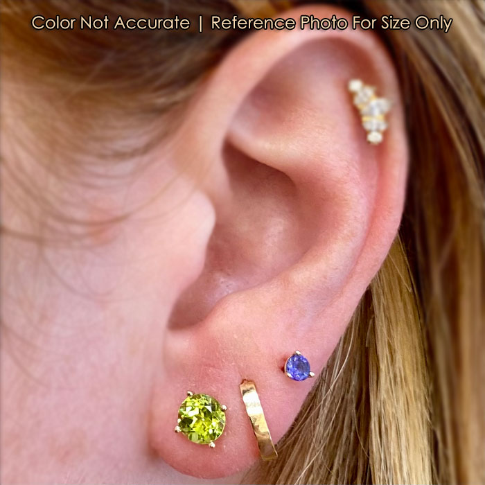 gold and peridot gem studs to ear