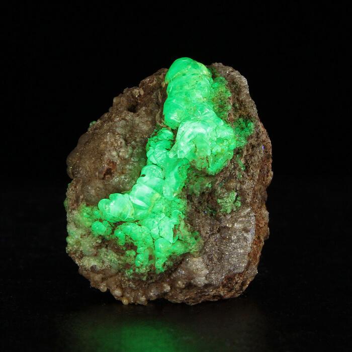 glowing green hyalite opal mineral specimen